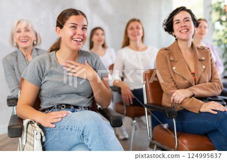 Young girl laughing while listening to master class in group auditorium 124995637