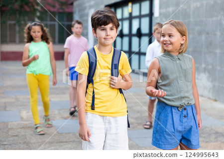 Young girl and boy walking together Young girl and boy walking together 124995643