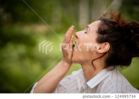 Woman in forest eating fresh wild berries on summer day natural food healthy eating theme. Woman harvesting and eating forest strawberry smiling in summer woods Woman in forest eating fresh wild berries on summer day natural food healthy eating theme. Woman harvesting and eating forest strawberry smiling in summer woods 124995734