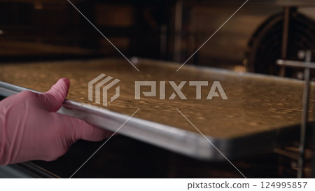 Pastry chef puts almond flour dough oven, bake. Making cake,gluten-free pastries 124995857