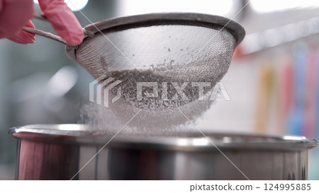 Woman Hands Sifting Flour Through Sieve, Baking pastry Prep,pizza dough or bread 124995885