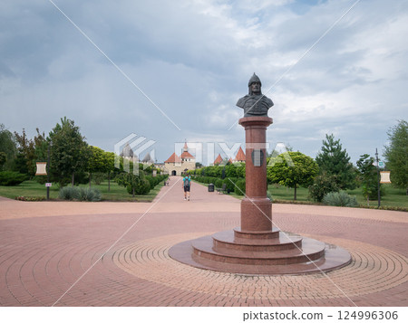 Historical square with warlord statue and medieval fortress in backdrop, Moldova, Europe 124996306