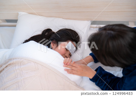 A mother nursing her child 124996483