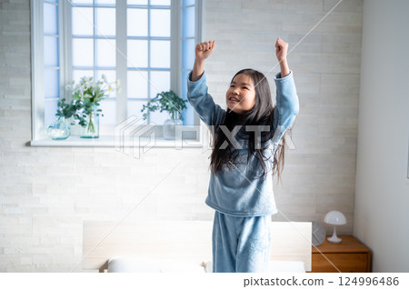 Girl happy in bed 124996486