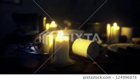 Candlelight illuminated dining table with scattered dishes and warm ambiance Candlelight illuminated dining table with scattered dishes and warm ambiance 124996878