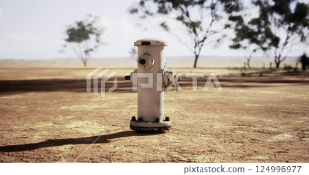 Hydrant standing alone in a dry landscape under a clear sky Hydrant standing alone in a dry landscape under a clear sky 124996977