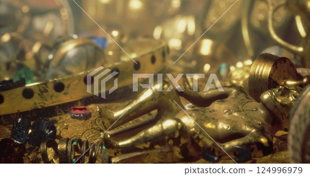 Golden artifacts and gems in a treasure chest in a mystery setting 124996979