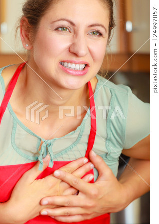 Woman suffering from having heart attack. Woman suffering from having heart attack. 124997057