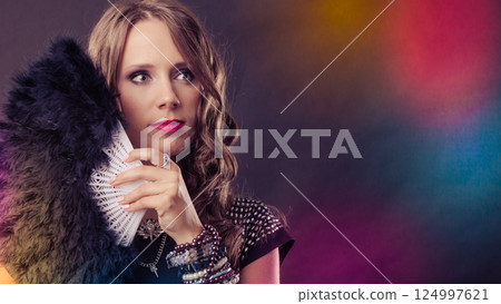 beautiful brunette woman with black fan in hand 124997621