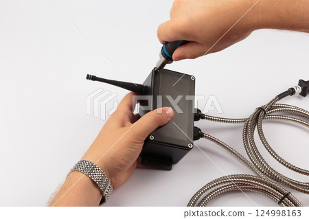 Hands of a master holding an electronic board on a Hands of a master holding an electronic board on a 124998163