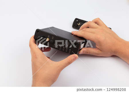 Hands of a master holding an electronic board on a 124998208