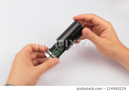 Hands of a master holding an electronic board on a Hands of a master holding an electronic board on a 124998229