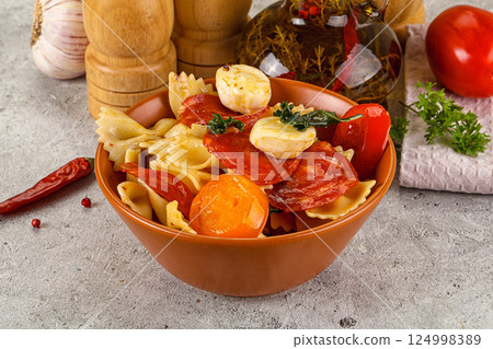 Italian pasta farfalle with pepperoni Italian pasta farfalle with pepperoni 124998389