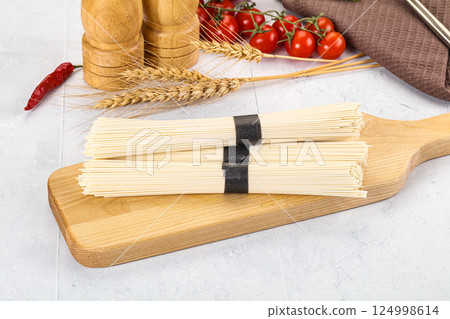 Raw dry white wheat noodles Raw dry white wheat noodles 124998614