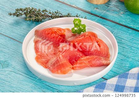 Delicous sliced salmon fillet  ready to eat 124998735