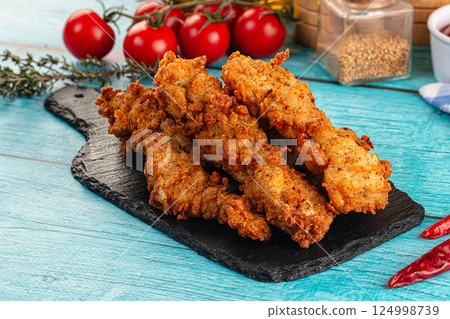 Golden crispy fried chicken strips 124998739