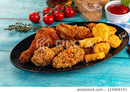 Golden crispy fried chicken mix - wings, drumsticks, nuggets and strips Golden crispy fried chicken mix - wings, drumsticks, nuggets and strips 124998741