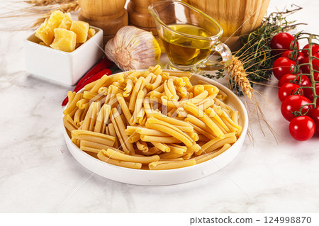 Raw dry Italian pasta - casarecce 124998870