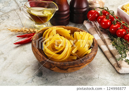 Raw dry Italian pasta - pappardelle 124998877