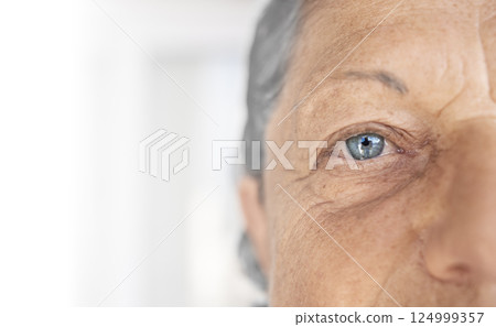 Close-up portrait of elderly woman with blue eyes 124999357