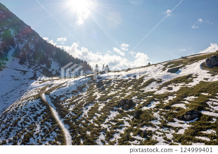 Drone shot of snowy pasture in autumn in the Bavarian Alps 124999401