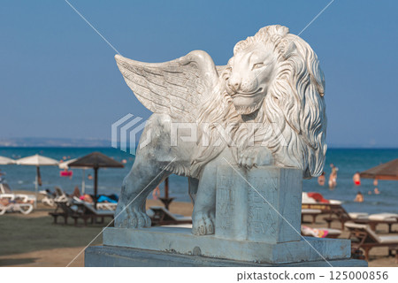 Winged Lion statue standing on Finikoudes beach in Larnaca, Cyprus, on a sunny summer day 125000856