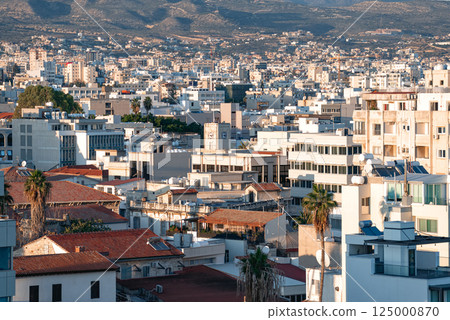 Cityscape of Limassol in Cyprus showing buildings and mountains in background 125000870
