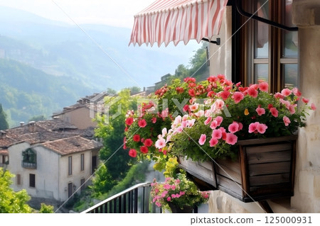 Blooming petunias decorating window box overlooking picturesque italian village 125000931