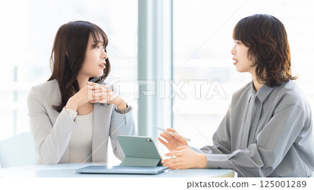 Two women/businesswomen having a meeting Two women/businesswomen having a meeting 125001289