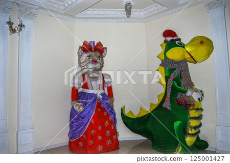 Costumed animated images of animals.Bright, colorful costumes in the form of a cat and a human-sized crocodile. 125001427