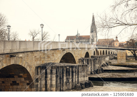 A scenic view of the old stone bridge crossing the Danube River in Regensburg, Germany, with the A scenic view of the old stone bridge crossing the Danube River in Regensburg, Germany, with the 125001680