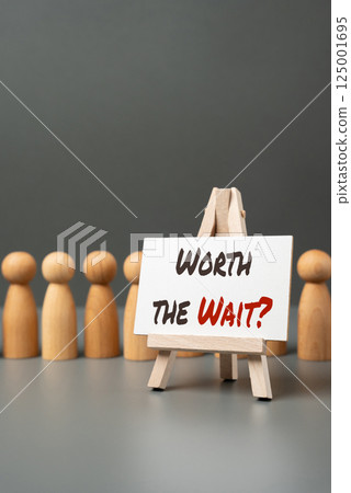 A line of people and a sign saying Worth the wait? Questioning whether the wait is worthwhile. Bureaucratic delays. Time investment and outcome. Customer service lines A line of people and a sign saying Worth the wait? Questioning whether the wait is worthwhile. Bureaucratic delays. Time investment and outcome. Customer service lines 125001695