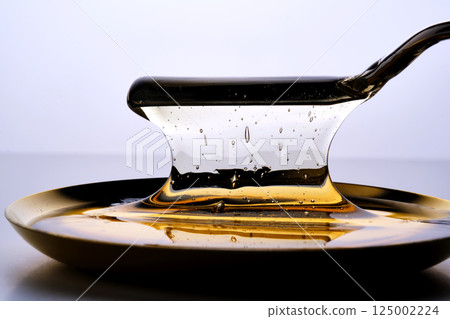 Photo of a sugar paste for depilation hair removal procedure. Texture. 125002224