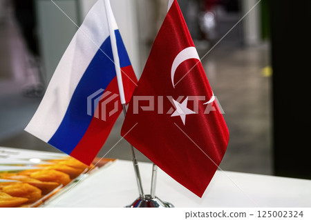 Russian and Turkish flags on table in meeting room. The concept of Russian Turkish cooperation. 125002324