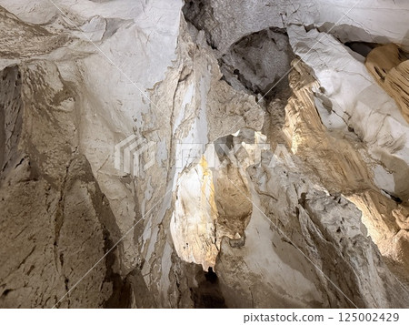Brown grunge background. Mountain texturelight brown rock in a cave tourism nature Brown grunge background. Mountain texturelight brown rock in a cave tourism nature 125002429