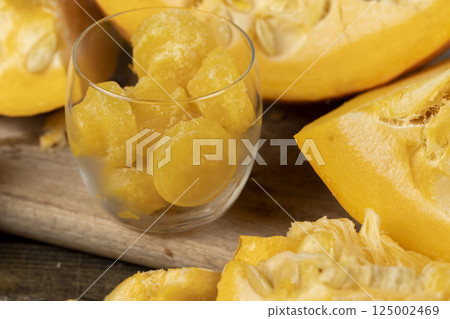 details of the pumpkin part with soft sweet flesh and large seeds And a glass with ice 125002469