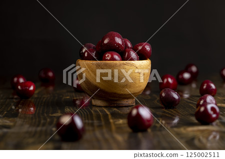 cherry in drops of water, wet cherry fruits on the kitchen table cherry in drops of water, wet cherry fruits on the kitchen table 125002511