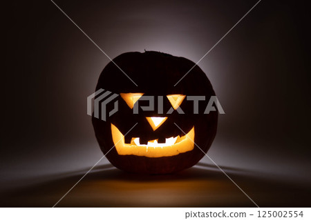one halloween pumpkin backlit background 125002554