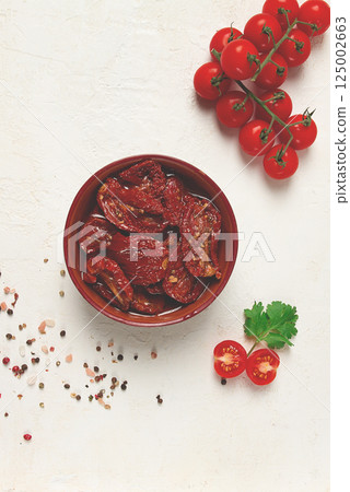 dried tomatoes, in a bowl, top view, on a white background, dried tomatoes, in a bowl, top view, on a white background, 125002663