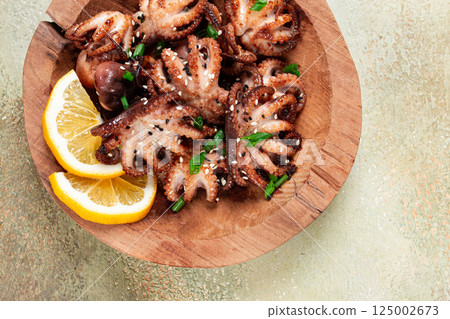 grilled baby octopus with green onions, lemon slices, on a wooden plate, homemade, no people, grilled baby octopus with green onions, lemon slices, on a wooden plate, homemade, no people, 125002673