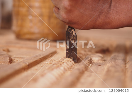 Crafting detailed woodwork with precision in a workshop environment Crafting detailed woodwork with precision in a workshop environment 125004015