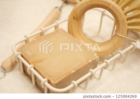 Natural soap and bamboo accessories on a soft surface Natural soap and bamboo accessories on a soft surface 125004269