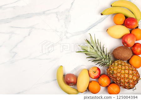 Detox diet and weight loss concept. Summer tropical fruits on marble table, source of vitamin C, store banner, healthy vegan products for healthy lifestyle, store advertisement. Detox diet and weight loss concept. Summer tropical fruits on marble table, source of vitamin C, store banner, healthy vegan products for healthy lifestyle, store advertisement. 125004394