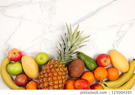 Summer tropical fruits on marble table, source of vitamin C, banner for shop, healthy vegan products for healthy lifestyle, detox diet and weight loss concept, shop advertisement. 125004395