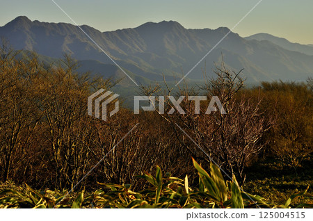 The Misaka mountain range illuminated by the morning sun, seen from Mount Ryugatake in the Tenshi Mountains 125004515