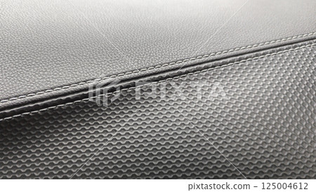 A detailed view of black material showing textures and stitching. High quality photo 125004612
