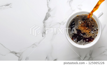 Coffee stream from above filling white cup, placed against marble background. Black coffee espesso 125005226