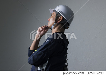 Elderly man wearing a helmet 125005290
