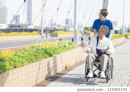 Senior men riding a wheelchair 125005379