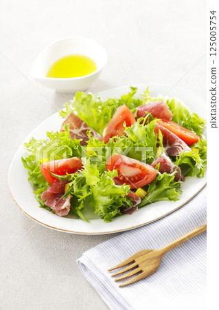 Tomato, prosciutto and leaf lettuce salad Tomato, prosciutto and leaf lettuce salad 125005754